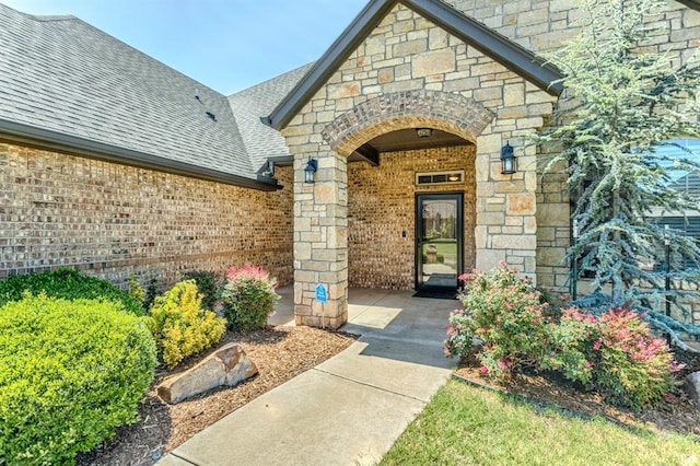 19633 Stratmore Way, Edmond, OK 73012 - entrance to property with a shingled roof, brick siding, and stone siding