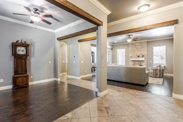 19633 Stratmore Way, Edmond, OK 73012 - living area featuring ceiling fan, arched walkways, wood finished floors, ornamental molding, and baseboards