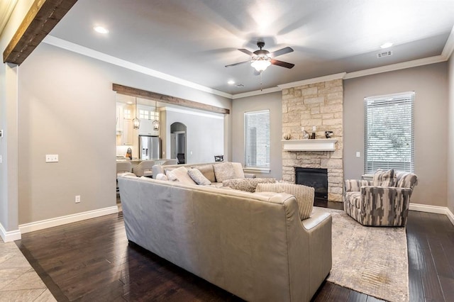 19633 Stratmore Way, Edmond, OK 73012 - living area with ceiling fan, a fireplace, arched walkways, baseboards, and ornamental molding