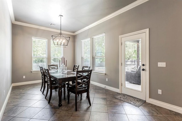 19633 Stratmore Way, Edmond, OK 73012 - tiled dining space with healthy amount of natural light, crown molding, a chandelier, and baseboards