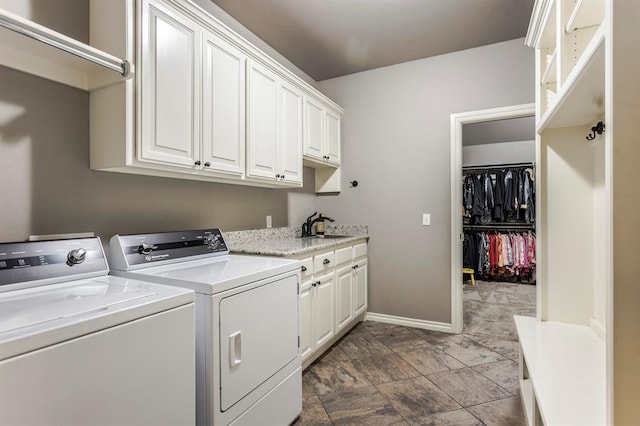 19633 Stratmore Way, Edmond, OK 73012 - laundry room featuring cabinet space, washer and dryer, and baseboards