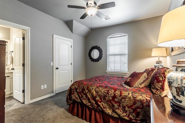 19633 Stratmore Way, Edmond, OK 73012 - bedroom with carpet, baseboards, vaulted ceiling, connected bathroom, and ceiling fan