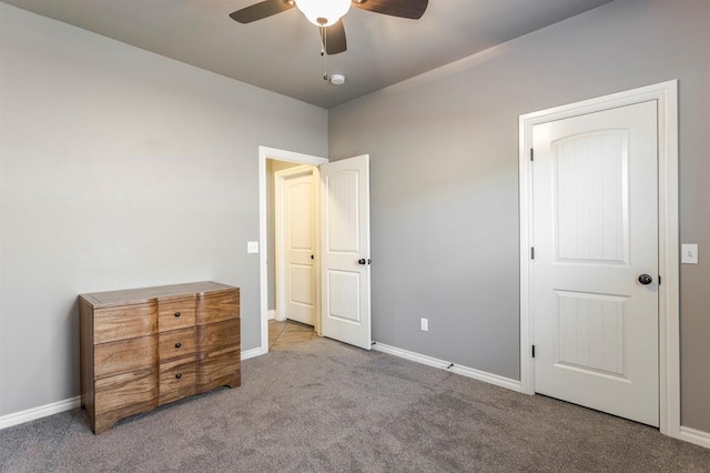 19633 Stratmore Way, Edmond, OK 73012 - unfurnished bedroom with carpet, baseboards, and a ceiling fan