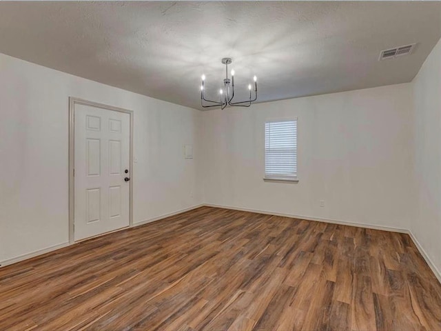 1619 SE 63rd St, Oklahoma City, OK 73149 - spare room featuring a chandelier, wood finished floors, and baseboards