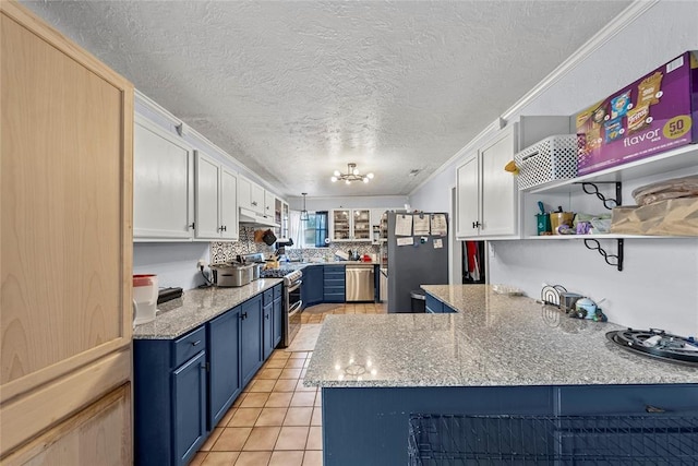 5505 S Villa Ave, Oklahoma City, OK 73119 - kitchen featuring stainless steel appliances, blue cabinetry, white cabinets, a textured ceiling, and light tile patterned flooring