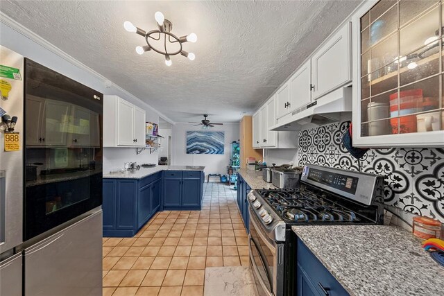 5505 S Villa Ave, Oklahoma City, OK 73119 - kitchen with double oven range, blue cabinetry, under cabinet range hood, white cabinetry, and a textured ceiling