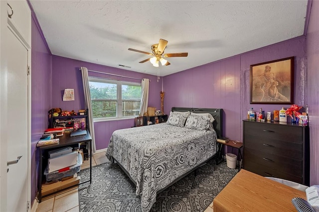 5505 S Villa Ave, Oklahoma City, OK 73119 - bedroom with light tile patterned floors, a textured ceiling, and a ceiling fan