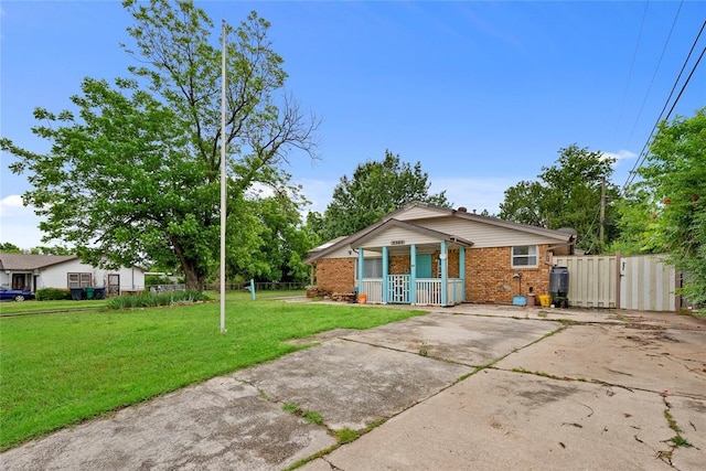 5505 S Villa Ave, Oklahoma City, OK 73119 - view of front of house featuring brick siding, a gate, covered porch, and driveway