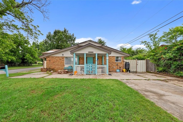 5505 S Villa Ave, Oklahoma City, OK 73119 - view of front of property with covered porch, brick siding, a gate, and driveway
