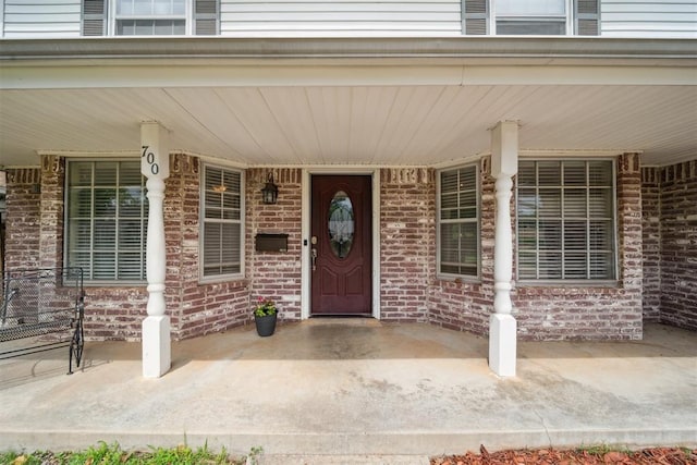 700 Nancy Lynn Ter, Norman, OK 73069 - view of exterior entry featuring covered porch and brick siding