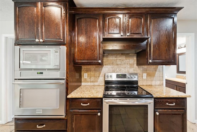 700 Nancy Lynn Ter, Norman, OK 73069 - kitchen featuring electric range, wall oven, white microwave, and dark brown cabinets
