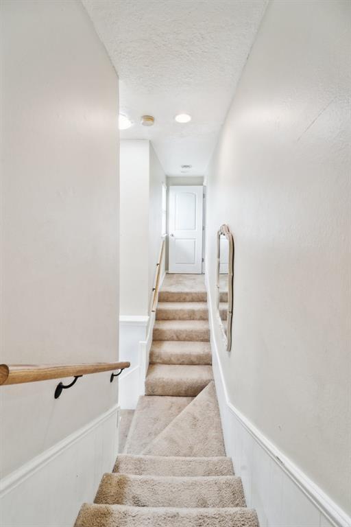 700 Nancy Lynn Ter, Norman, OK 73069 - stairs featuring a textured ceiling