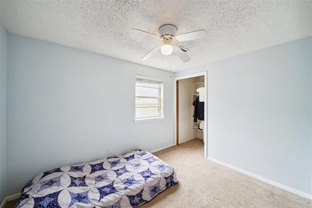 700 Nancy Lynn Ter, Norman, OK 73069 - carpeted bedroom featuring baseboards, a textured ceiling, and ceiling fan
