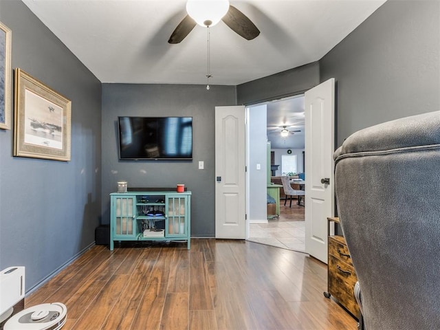 419 NE 23rd Ter, Newcastle, OK 73065 - living room featuring a ceiling fan, wood finished floors, and baseboards