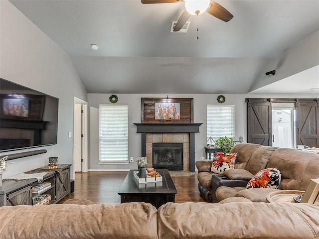 419 NE 23rd Ter, Newcastle, OK 73065 - living room with vaulted ceiling, dark wood-style floors, a ceiling fan, a tiled fireplace, and baseboards