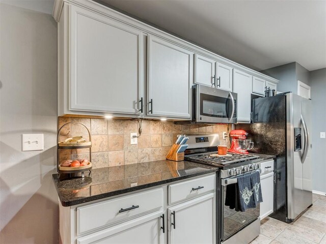419 NE 23rd Ter, Newcastle, OK 73065 - kitchen featuring stainless steel appliances, backsplash, and dark stone counters
