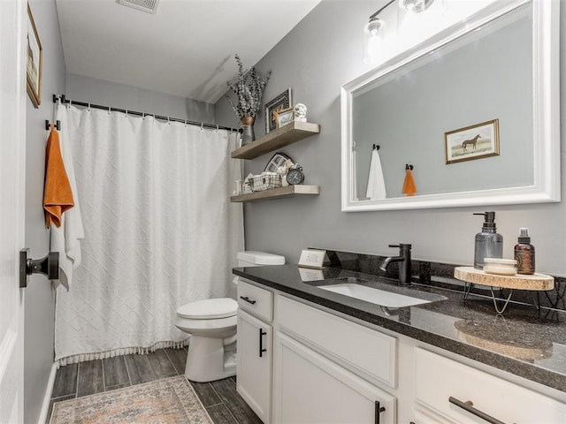 419 NE 23rd Ter, Newcastle, OK 73065 - bathroom featuring toilet, wood finished floors, vanity, and a shower with curtain