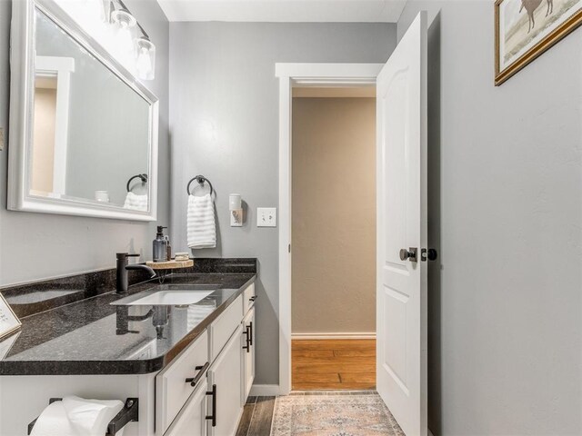 419 NE 23rd Ter, Newcastle, OK 73065 - bathroom with vanity, wood finished floors, and baseboards