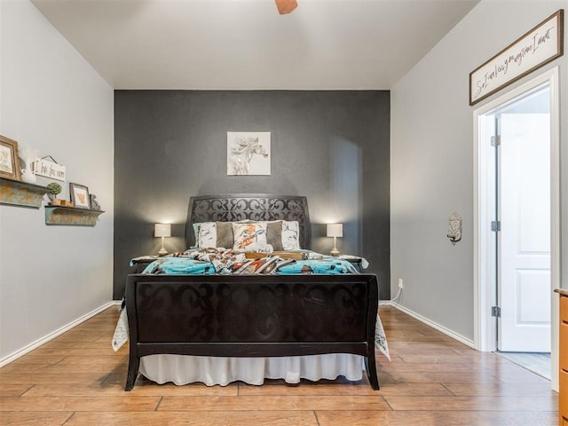 419 NE 23rd Ter, Newcastle, OK 73065 - bedroom featuring an accent wall, wood finished floors, and baseboards