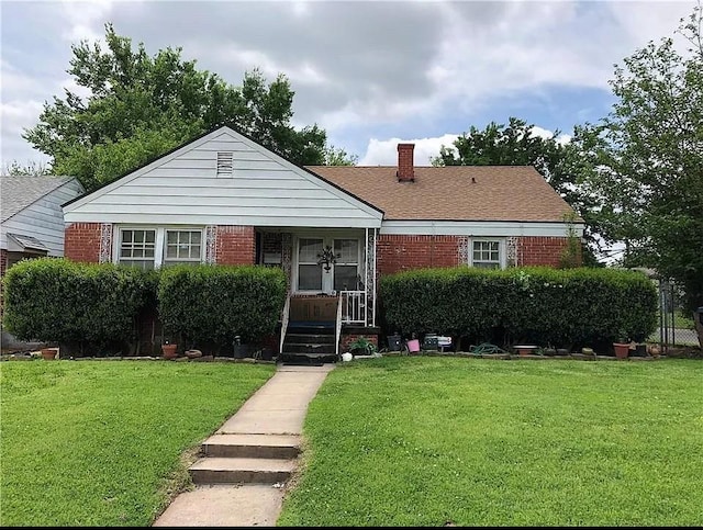 2200 Hardin Dr, Oklahoma City, OK 73111 - bungalow featuring brick siding, a front lawn, and a chimney