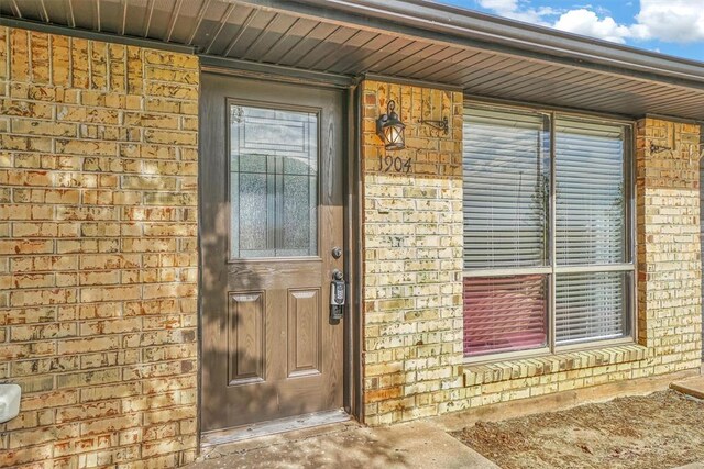 1904 Gemini St, Altus, OK 73521 - property entrance featuring brick siding
