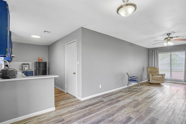 1904 Gemini St, Altus, OK 73521 - kitchen featuring blue cabinetry, freestanding refrigerator, light wood-type flooring, light countertops, and ceiling fan
