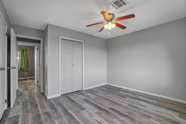 1904 Gemini St, Altus, OK 73521 - unfurnished bedroom with wood finished floors, baseboards, a closet, and a ceiling fan