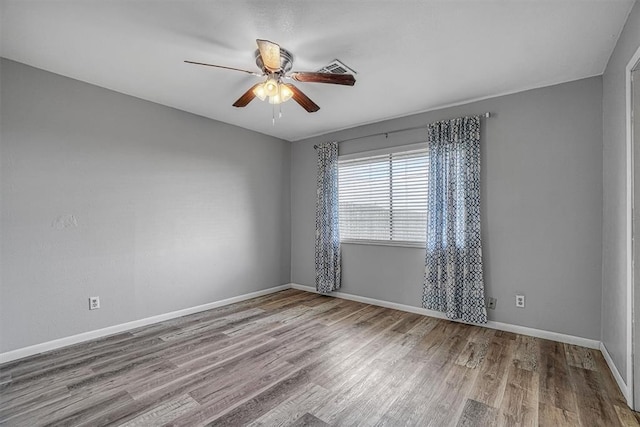 1904 Gemini St, Altus, OK 73521 - unfurnished room with wood finished floors, a ceiling fan, and baseboards