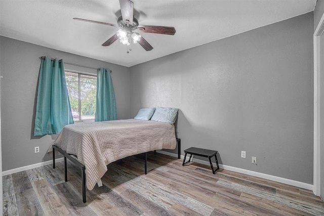 1904 Gemini St, Altus, OK 73521 - bedroom with wood finished floors, baseboards, and a ceiling fan
