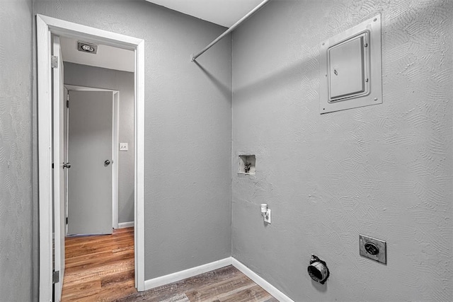 1904 Gemini St, Altus, OK 73521 - laundry area featuring wood finished floors, electric panel, hookup for an electric dryer, baseboards, and washer hookup