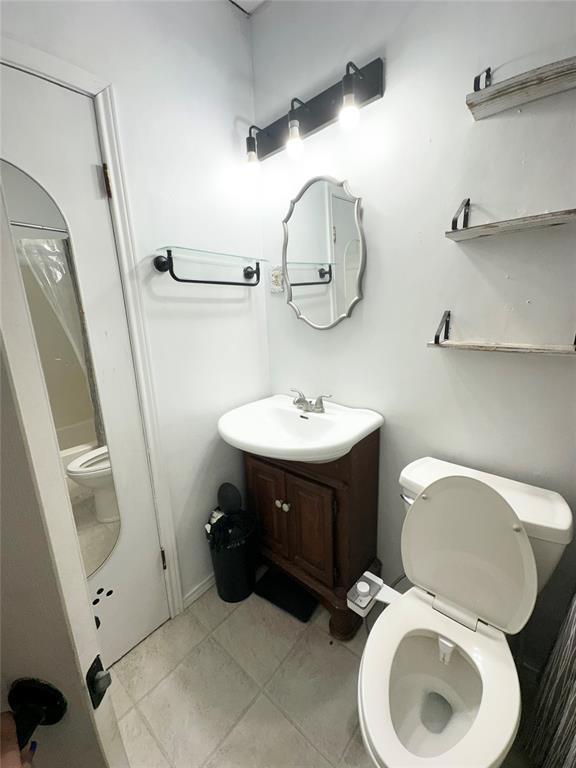 1024 Zinn Ave, Blair, OK 73526 - bathroom with toilet, vanity, and tile patterned floors