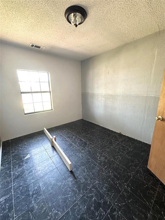 1024 Zinn Ave, Blair, OK 73526 - unfurnished room featuring a textured ceiling