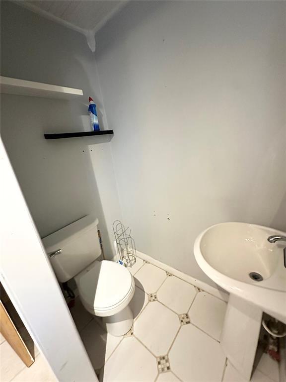 1024 Zinn Ave, Blair, OK 73526 - half bath with toilet and tile patterned floors