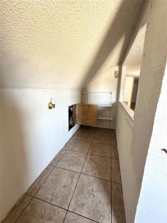 1024 Zinn Ave, Blair, OK 73526 - additional living space with light tile patterned floors, a textured ceiling, and vaulted ceiling