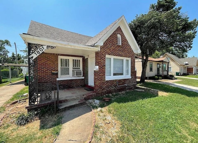 1801 N Jordan Ave, Oklahoma City, OK 73111 - view of front of home with brick siding, a shingled roof, and a front yard
