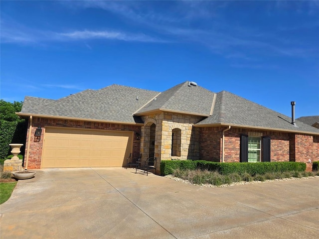 5608 NW 127th St, Oklahoma City, OK 73142 - french country style house with driveway, an attached garage, a shingled roof, and brick siding