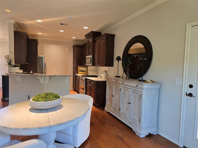 5608 NW 127th St, Oklahoma City, OK 73142 - kitchen with stainless steel appliances, dark brown cabinets, dark wood-style flooring, ornamental molding, and recessed lighting
