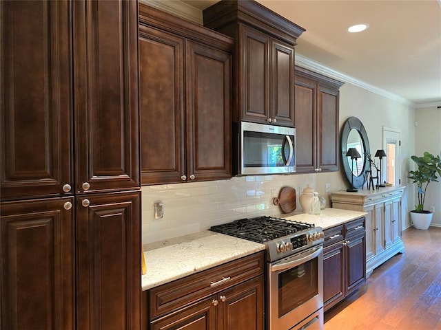 5608 NW 127th St, Oklahoma City, OK 73142 - kitchen featuring appliances with stainless steel finishes, backsplash, light wood-style floors, light stone counters, and baseboards