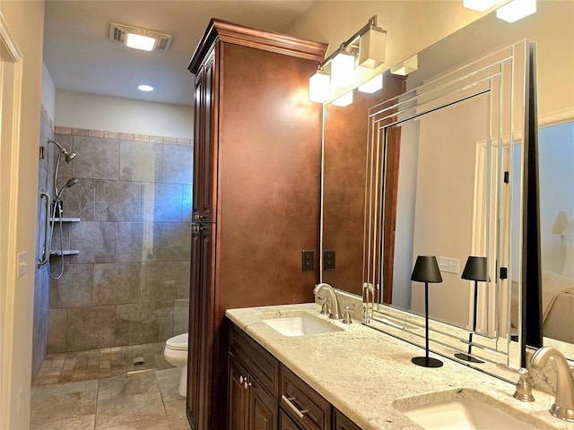 5608 NW 127th St, Oklahoma City, OK 73142 - bathroom with toilet, double vanity, tiled shower, and recessed lighting