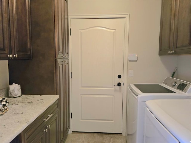 5608 NW 127th St, Oklahoma City, OK 73142 - laundry room featuring cabinet space, washing machine and dryer, and light tile patterned floors