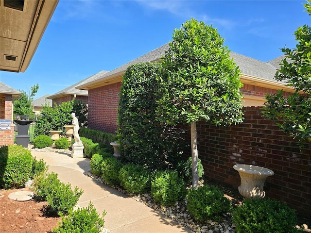 5608 NW 127th St, Oklahoma City, OK 73142 - view of side of home with brick siding and roof with shingles