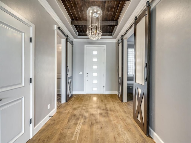832 Gateway Bridge Rd, Edmond, OK 73034 - corridor featuring a barn door, light wood-style floors, a tray ceiling, wooden ceiling, and a chandelier