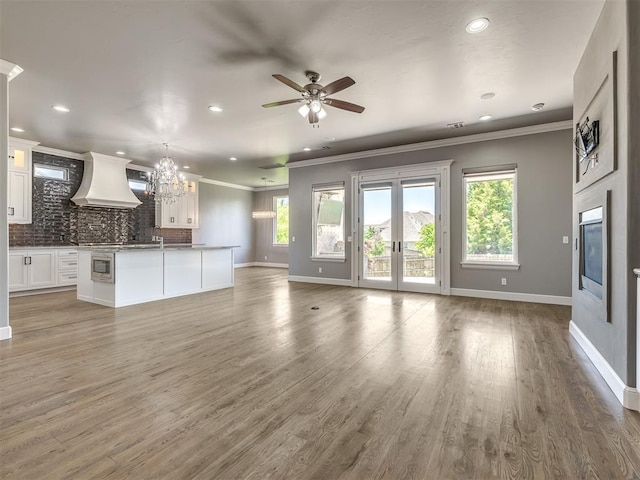832 Gateway Bridge Rd, Edmond, OK 73034 - unfurnished living room with ornamental molding, baseboards, ceiling fan, plenty of natural light, and recessed lighting