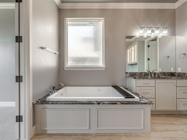 832 Gateway Bridge Rd, Edmond, OK 73034 - full bathroom with vanity, a garden tub, plenty of natural light, and ornamental molding