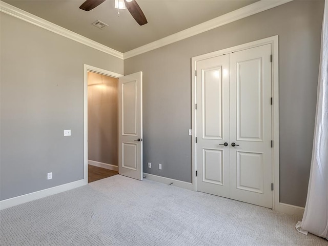 832 Gateway Bridge Rd, Edmond, OK 73034 - unfurnished bedroom featuring crown molding, carpet floors, baseboards, a closet, and ceiling fan