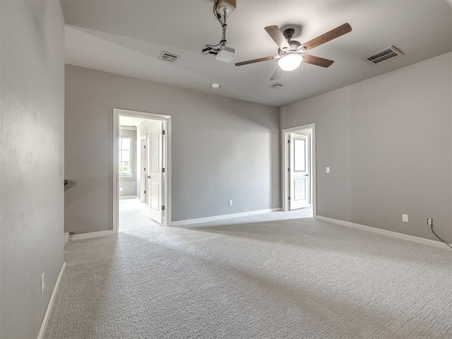 832 Gateway Bridge Rd, Edmond, OK 73034 - empty room featuring a ceiling fan, light carpet, and baseboards