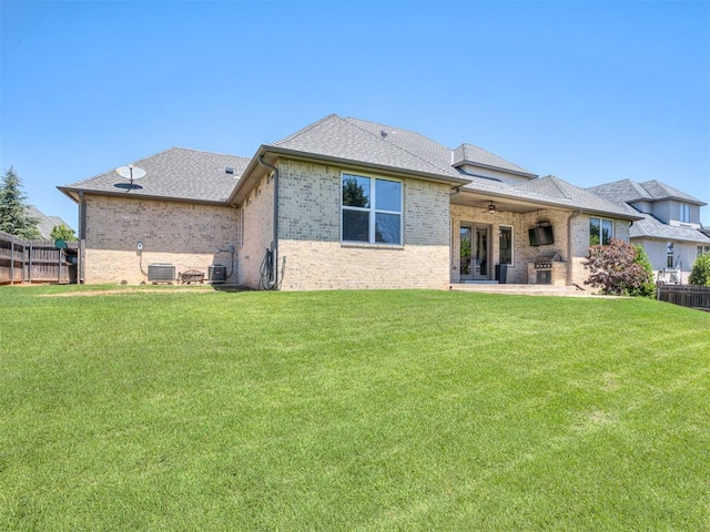 832 Gateway Bridge Rd, Edmond, OK 73034 - back of property with brick siding, ceiling fan, a patio area, central AC, and a shingled roof