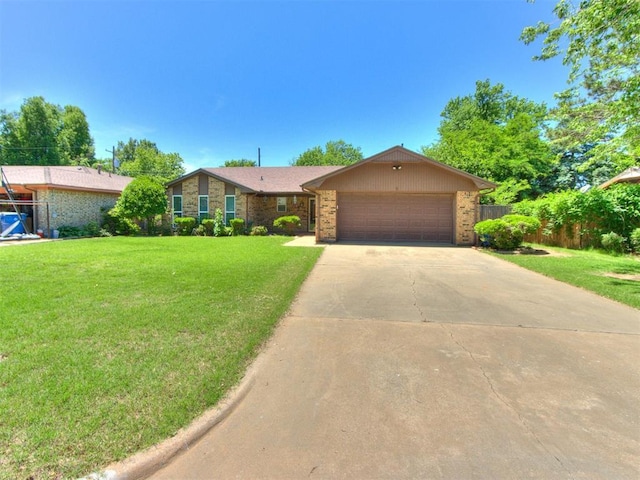 ranch-style home featuring a garage, concrete driveway, and brick siding
