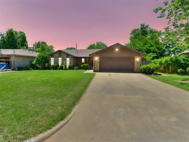 mid-century home featuring an attached garage and driveway