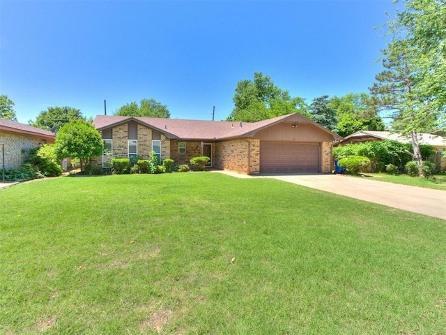 view of front of home featuring a garage, a front yard, driveway, and brick siding